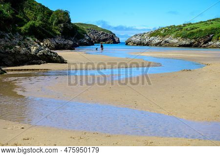 View On Playa De Poo During Low Tide Near Llanes, Green Coast Of Asturias, North Spain With Sandy Be
