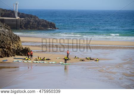 Young Surfers Train On Playa De Palombina Las Camaras In Celorio, Green Coast Of Asturias, North Spa