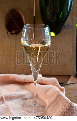 Glass Of Sparkling White Wine Champagne Or Cava With Bubbles And Classic Wooden Champagne Pupitre Ra