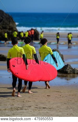 Young Surfers Train On Playa De Palombina Las Camaras In Celorio, Green Coast Of Asturias, North Spa