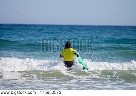 Young Surfers Train On Playa De Palombina Las Camaras In Celorio, Green Coast Of Asturias, North Spa