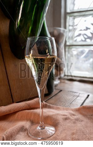 Glass Of Sparkling White Wine Champagne Or Cava With Bubbles And Classic Wooden Champagne Pupitre Ra