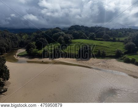 Aerial View On Playa De Poo During Low Tide Near Llanes, Green Coast Of Asturias, North Spain With S