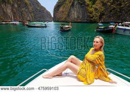 Beautiful Young Blonde Woman In Orange Dress On A Boat Posing During Excursion In Pi Leh Lagon Of Ph