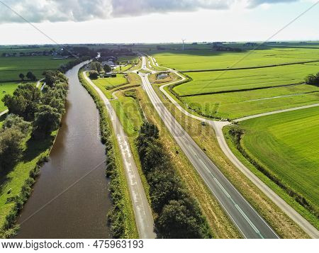 Canal Along Three Different Roads Proportional To Each Other Through The Meadow And Forest In The Ba