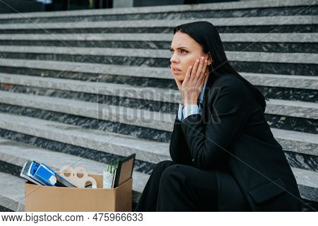 Woman Sitting On Stairs, Symbolizing The Struggle Of Job Loss And Worklessness Due To Dismissal And 