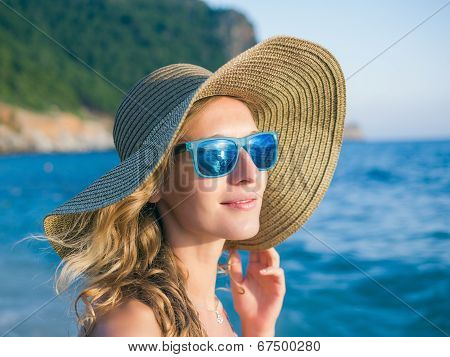 A Girl In A Hat On The Beach