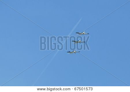 BERLIN, GERMANY - MAY 21, 2014: Aerobatic team 3x Fly Sinthesis Texan Top Class (Wefly team, Italy) demonstration during the International Aerospace Exhibition ILA Berlin Air Show-2014.