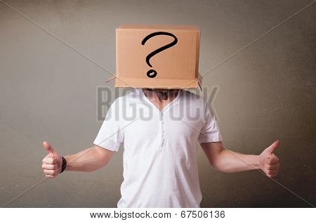 Young man standing and gesturing with a cardboard box on his head with question mark