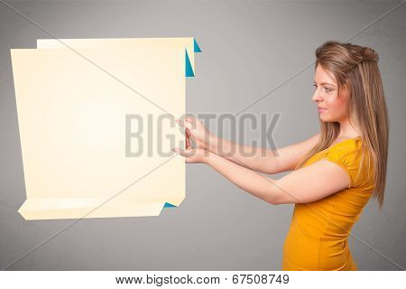 Baeutiful young woman holding white origami paper copy space