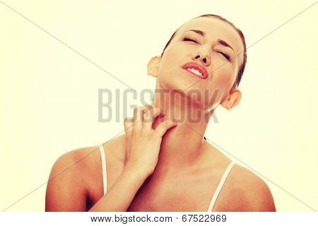 Young beautiful woman scratching her neck.