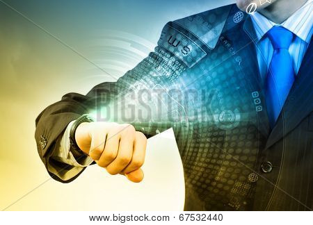 Businessman looking at wristwatch. Media technologies and innovations