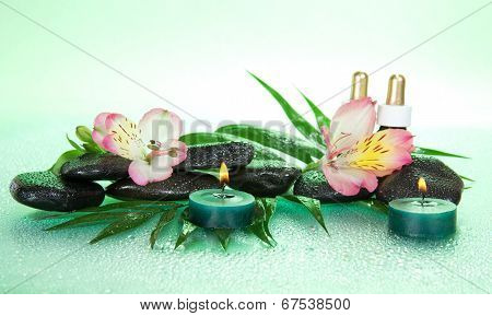 Candles and aroma oil, stones, flower