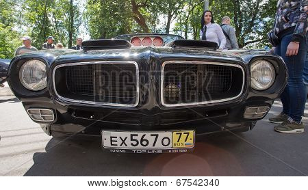 The black sports car with the air inlet taken out outside on show of collection Retrofest cars
