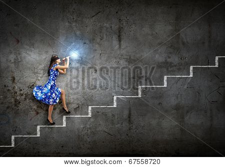 Young woman in blue dress playing fife and stepping the ladder