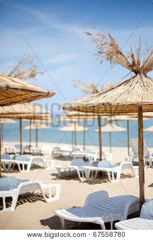 View of the sand beach with straw parasols