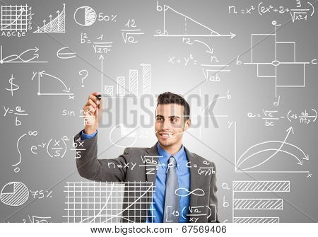 Businessman writing math formulas