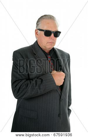 A well dress man pulls his Pocket Pistol from his vest pocket when he faces danger as a CIA Mole or Mafia King Pin or some other nefarious Character.  isolated on white with room for your text. 
