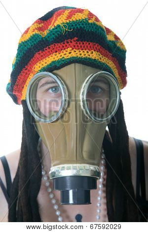a girl in a gas mask wears her favorite Rastafarian style hat with built in Dred locks. isolated on white with room for your text.