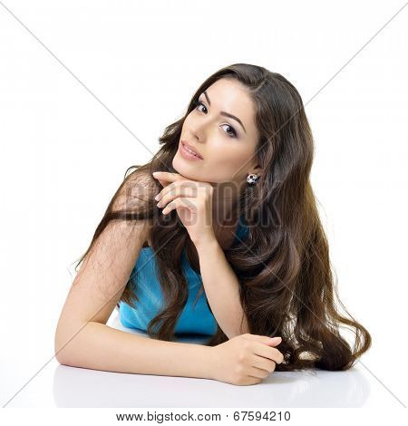 Beautiful happy girl lying and looking at camera. Isolated on white background