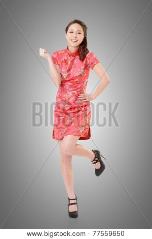 Smiling Chinese woman dress traditional cheongsam at New Year, studio shot isolated.
