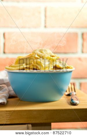 cooked ravioli in bowl on kitchen table