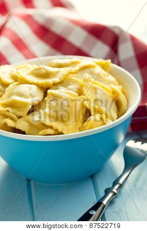 cooked ravioli in bowl on kitchen table