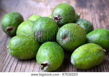 Green feijoa fruit on wooden table
