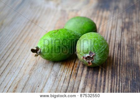 Green feijoa fruit on wooden table