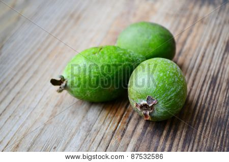 Green feijoa fruit on wooden table
