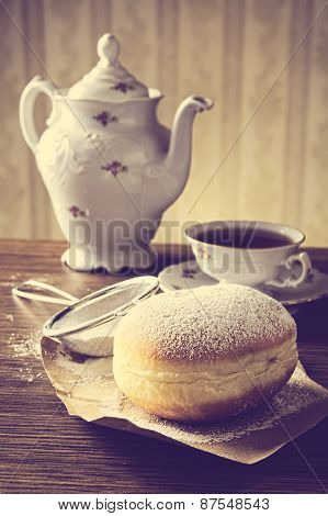 Closeup Shot Of Donut With Cup Of Tea On Table In Old-fashioned