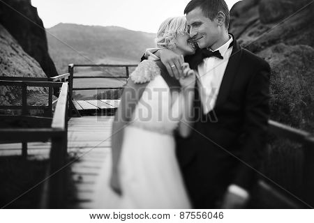 wedding couple walking on the bridge in the mountains