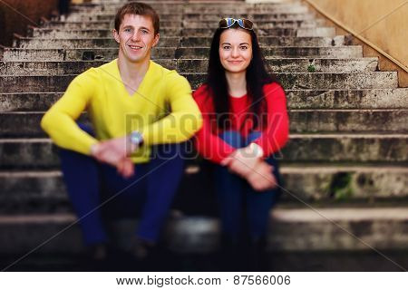Portrait Of Couple Sitting On Stairs And Kising In Rome