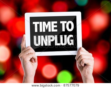 Tablet pc with text Time To Unplug with bokeh background