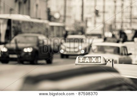 Taxi On City Streets Of Beige Color