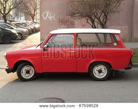 PRAGUE CZECH REPUBLIC - CIRCA MARCH 2015: Red Trabant car parked in a street of the city centre.