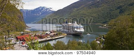 FLAAM, NORWAY - JUN 9 2015 : A cruise ship waits for returning passengers on the Aurlandsfjord.