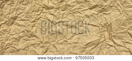 Close-up Of Rough Golden Brown Wrinkled Packaging Paper Texture Background