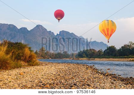Hot Air Balloon Over River In Vangvieng