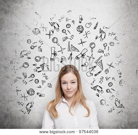 Young Beautiful Student Is Thinking About Education At Business School. Drawn Business Icons Over Th