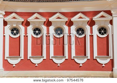 Exterior of the red painted stables building windows next to Rundale palace in Pilsrundale, Latvia.