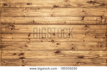Light brown wood texture background viewed from above. The wooden planks are stacked horizontally and have a worn look. This surface would be great as design element for a wall floor table etc...