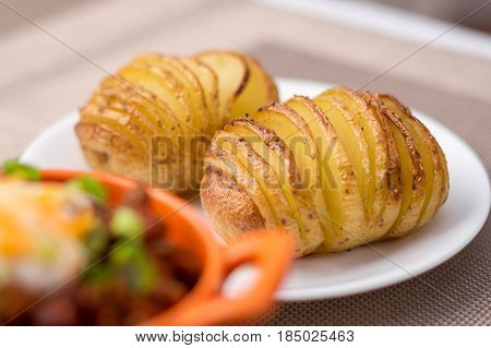Baked hasselback potatoes. Side dish of oven baked & roasted hasselback potatoes.