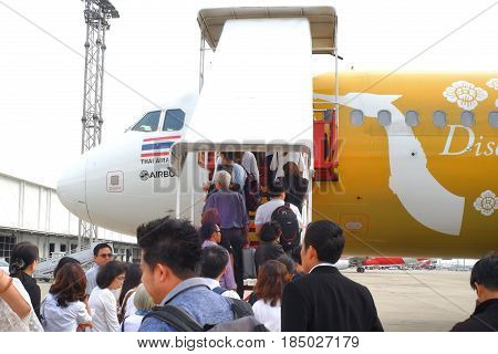 BANGKOK, THAILAND - 30 APRIL 2017: Many passengers going up to a plane with airasia airline at the gate in Don Mueang international airport (DMK)