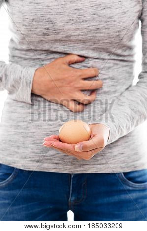 woman with egg allergy or an spoiled egg is having painful cramps