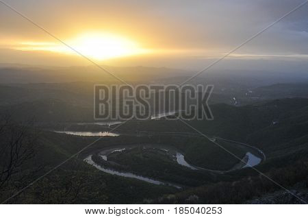 Misty morning and sunrise on mountain. Panoramic view on meanders of Morava river  from Kablar, Serbia