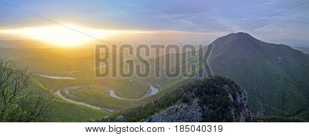 Misty morning and sunrise on mountain. Panoramic view on meanders of Morava river  from Kablar, Serbia