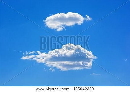 Two white clouds in blue sky on sunny day
