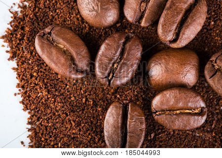 roasted coffee beans isolated in white background. Roasted coffee beans background close up. Coffee beans pile on the background of ground coffee with copy space for text. Good morning.