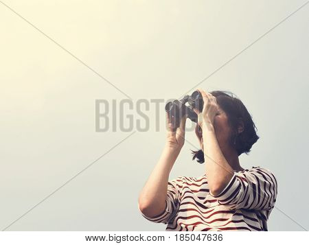 Woman using binocular explore searching